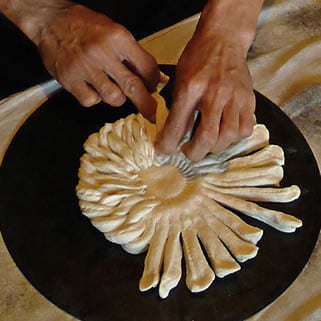 Raushanbek Ismailov is a nonvoy—a bread baker; here, he braids a decorative, Tashkent-style non.