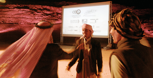Bedouin actors greet each other at the screening of Theeb while Toukan, lower, greets viewers. 