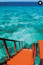 Stairway to a diver’s heaven, a resort villa opens to the crystalline Indian Ocean that floats both the Maldives’ tourism economy and the country’s concerns for its future.