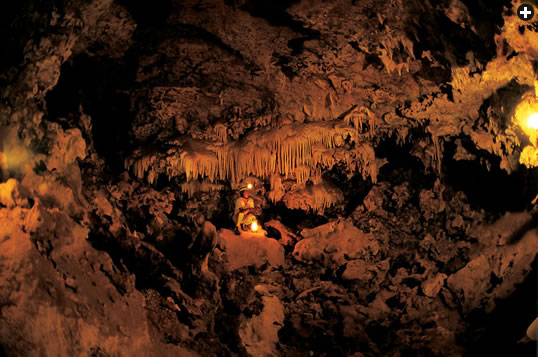 Accessible only through rough and narrow passages, Mossy Cave’s ceilings are covered with stalactites, which are deposits of crystallized limestone (calcite) left behind when mineral-bearing water drips from a gap in the ceiling.