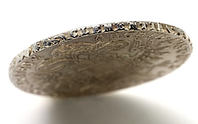 Look at the letters imprinted along the rim of this Maria Theresa thaler. They spell the Latin word clementia and were part of Empress Maria Theresa’s motto, IUSTICIA ET CLEMENTIA (“justice and clemency”), which appeared on the rim. 